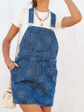 Blue denim overall dress with flower wide strap and pockets made of durable denim machine wash cold safe