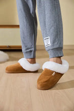 Brown suede slippers with white faux fur lining and fluff trim round toe flat design