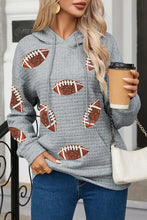 Women’s gray textured drawstring football long sleeve hoodie with glittery patterns