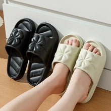 Two pairs of open toe flats slippers with clover design in black and cream