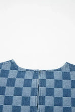 Back view of blue and light blue checkered denim mini dress with frayed hem and central zipper for casual wear