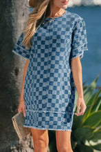 A frayed hem checkered denim mini dress with short flutter sleeves in a classic blue denim fabric
