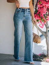High-waisted wide leg jeans in blue denim featuring a frayed hem for a stylish casual look