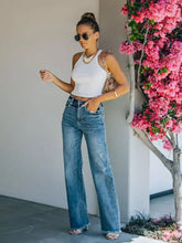 High-waisted blue denim wide leg jeans with frayed hem and straight-leg cut for casual stylish wear
