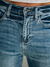 Medium-wash blue denim frayed hem high-waisted wide leg jeans with classic five-pocket design and gold-toned hardware
