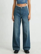 High-waisted blue denim jeans with a wide leg cut and frayed hem in a frayed hem wide design