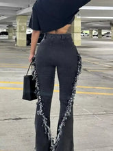 Black denim flare jeans with a frayed hem and raw hem textured side panels high waist design
