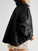 Free People black distressed denim jacket with frayed hem and pockets