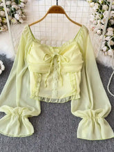 Frill flounce sleeve blouse is a pale yellow sheer long-sleeved crop top with ruffled sleeves and front bow detail