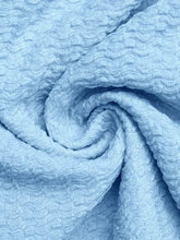 Light blue frill tube top with buckle detail made of textured waffle-like fabric for stylish casual wear
