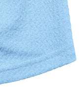 Light blue frill tube top with buckle detail made of textured fabric featuring a subtle repeating wave pattern