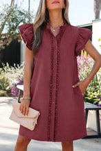 A maroon sleeveless denim mini dress with ruffled shoulders and button-front placket featuring ruffle trim