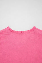 A vibrant pink textured blouse with frilled neck flower embroidered puff sleeves and a delicate ruffled neckline