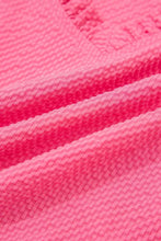 Bright pink frilled v neck blouse with flower embroidered puff textured waffle fabric and embroidered puff sleeve detail