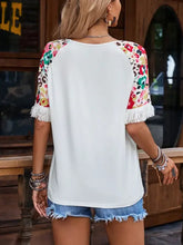 Fringe round neck white blouse with floral half sleeve and fringed hem
