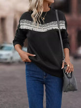 Black crew neck long-sleeved sweater with white geometric embroidery and fringe trim, machine wash and tumble dry safe