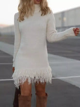 White long-sleeved turtleneck knit sweater dress with fringed hem