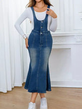 Blue denim overall dress with button closures, fitted waist, flared hem, slightly stretchy fabric, machine wash cold safe