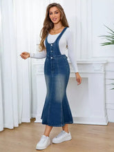 Front-button adjustable fishtail sleeveless denim overall dress with a fitted flared skirt in slightly stretchy fabric machine wash cold