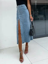 A light-wash midi denim skirt with a front button slit and high slit detail for stylish casual wear