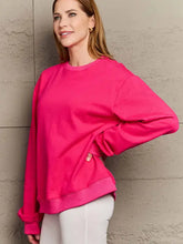 Woman in fuchsia pink oversized dropped shoulder sweatshirt and pants