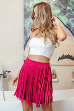 Fuchsia suede skirt with fringe accents and white crop top