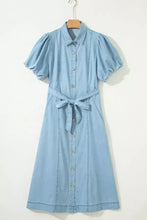 Light blue denim dress with full buttons collared short bubble sleeves and a self-tie belt
