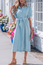 Light blue denim dress with buttons collared short bubble sleeves and self-tie belt in midi length