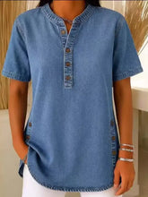 A medium-wash denim full size button detail short sleeve blouse with button-down front and side pockets
