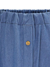 Full size button-front denim a-line skirt in blue denim with gathered waistband and a single wooden button closure
