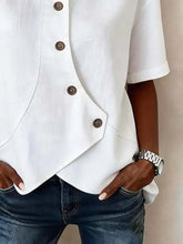 Full size casual asymmetrical white blouse with short sleeves and dark brown buttons on diagonal placket