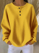 Bright yellow full size casual waffle knit henley top with black buttons made of slightly stretchy material