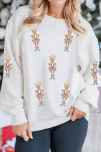 Cream-colored full size corded rib slightly stretchy drop shoulder sweatshirt with pink and gold glittery nutcracker appliqués