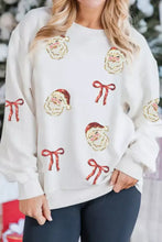 Cream-colored plus size knit sweater with sequin santa bow patches and corded rib detailing with care instructions