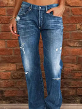 Full size plus size distressed raw hem blue denim flare jeans with intentional rips and faded patches