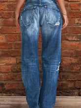 Full size plus size blue denim jeans with a distressed raw hem and subtle fading in a worn-in style