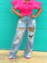Full size distressed wide-leg jeans plus size in light blue denim with high waist extensive rips and frayed edges