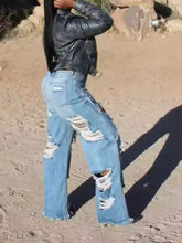 Full size distressed wide-leg jeans in blue denim with frayed edges and ripped knees plus size fit