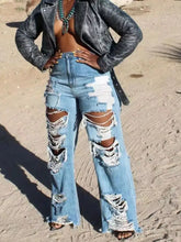Full size distressed wide-leg jeans plus size in light-wash denim with extensive rips and frayed edges on thighs and knees