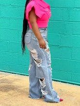 Light-wash denim full size distressed wide-leg jeans with ripped details along the legs in plus size fit