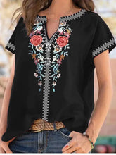 Black plus size floral notched short sleeve blouse with vibrant red blue and white embroidery along neckline and sleeves