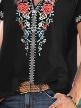 Black plus size floral notched short sleeve blouse with vibrant red blue and white embroidery along the neckline