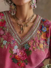 A vibrant pink blouse plus size with floral v neck featuring intricate red blue and green embroidery and beaded trim