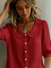A vibrant red full size button-down shirt with a classic peter pan collar and white buttons down the front