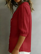 A vibrant red plus size button-down shirt with a full size peter pan collar and puffed short sleeves