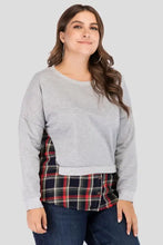 Women’s grey sweatshirt layered over plaid patch drop shoulder round neck top with dark wash jeans