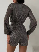 Shimmering silver sequin surplice tie waist long sleeve romper