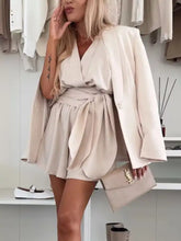 Beige surplice tie waist romper with shorts, belted oversized blazer