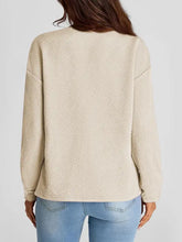Women’s full size texture round neck long sleeve sweatshirt with beige texture and light wash jeans