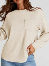 Textured beige full-size round neck long sleeve sweatshirt with chest pocket